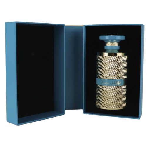 Opened luxury box of Forever Gold Eau de Parfum for men by Ard Al Zaafaran, revealing the gold and blue accented perfume bottle seated in a soft, blue-lined interior.