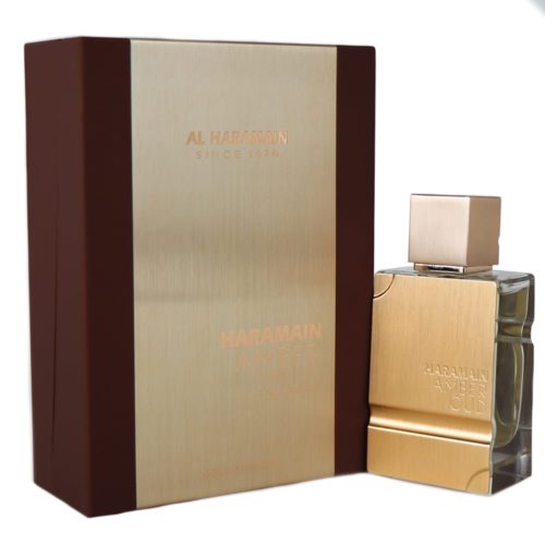 The "Amber Oud Gold Edition" perfume box positioned next to the bottle, showcasing the complementary design of the golden box and matching perfume container.