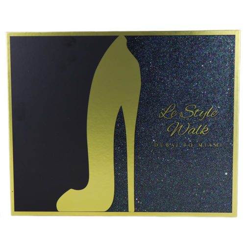 The front of the "Le Style Walk" gift set box, featuring a gold high-heel silhouette and a glittery black background with text that reads "Dubai to Miami."
